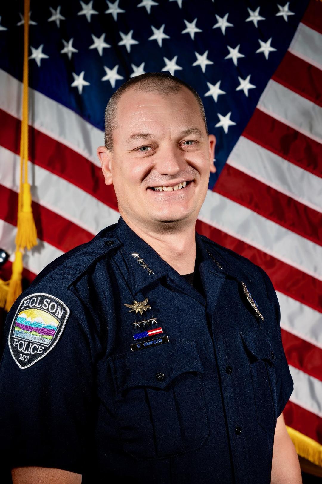 Chief George Simpson at his desk in uniform